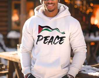 May include: White hooded sweatshirt with a Palestinian flag graphic and the word "PEACE" in black brushstroke lettering.