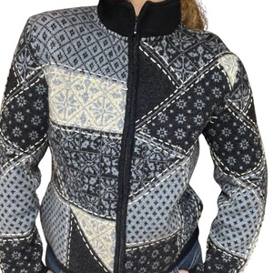 May include: A black, grey, and white patterned zip-up cardigan with a high collar.