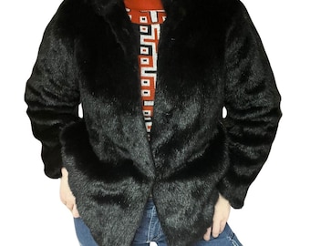 May include: A black faux fur jacket with a collar and a button closure.