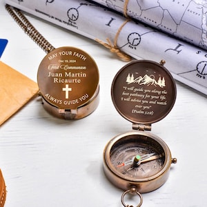 May include: A brass compass with a quote about faith and guidance engraved on the inside of the lid. The lid also has a cross and the text "May Your Faith Always Guide You". The compass is a gift for a First Communion.