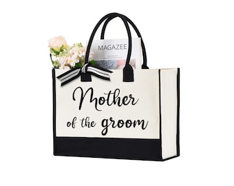 May include: A white canvas tote bag with black trim and handles. The bag has the text "Mother of the groom" printed in black on the front.