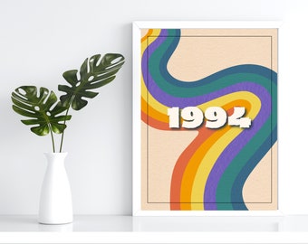 May include: A white framed print with a retro rainbow design and the year 1992 in white text.
