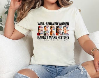 May include: White t-shirt with a graphic print of famous women and the text "Well-behaved women rarely make history". The graphic includes Frida Kahlo, Amelia Earhart, Maya Angelou, Ruth Bader Ginsburg, and Malala Yousafzai.