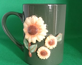 Green cup with sunflowers