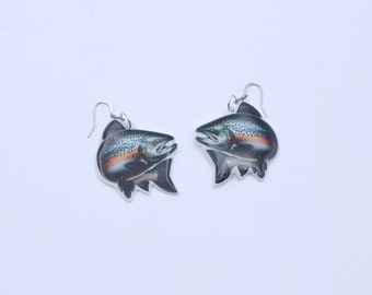 May include: A pair of silver dangle earrings featuring a realistic image of a trout fish.