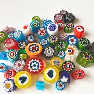 May include: Assortment of colourful glass beads with various patterns, including flowers, hearts, and geometric designs. The beads are perfect for jewellery making, crafting, and home decor.