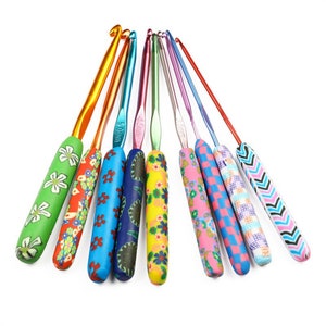 May include: A set of ten colourful crochet hooks with different patterned handles. The hooks are made of metal and have a variety of sizes. The handles are made of a soft, flexible material and are decorated with different patterns.