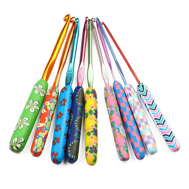 May include: A set of ten colourful crochet hooks with different patterned handles. The hooks are made of metal and have a variety of sizes. The handles are made of a soft, flexible material and are decorated with different patterns.