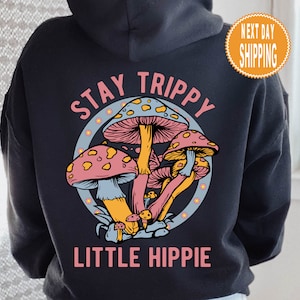May include: Black hoodie with a graphic of colorful mushrooms and the text "Stay Trippy Little Hippie".