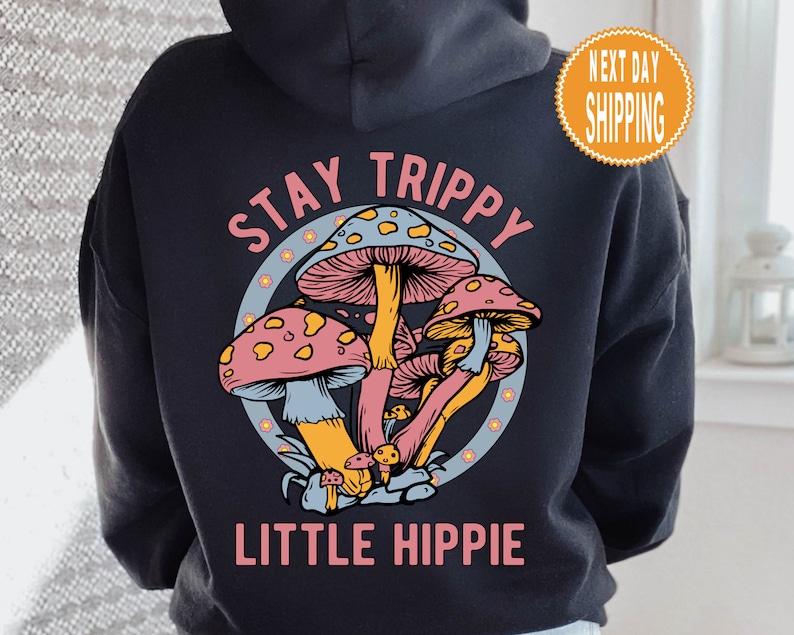 May include: Black hoodie with a graphic of colorful mushrooms and the text "Stay Trippy Little Hippie".