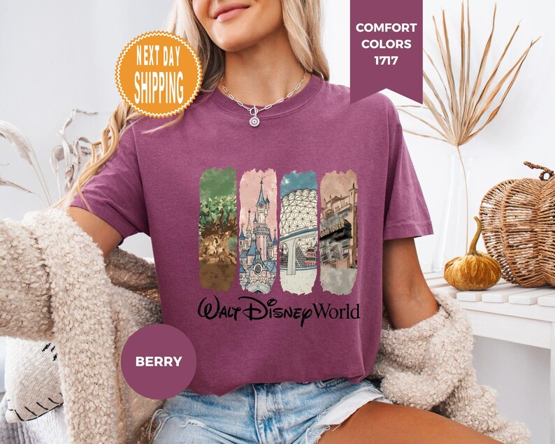 May include: A white ceramic mug with a black handle and the text "But First, Coffee" in a bold, black font. The mug is set against a blurred background, suggesting a cozy setting.