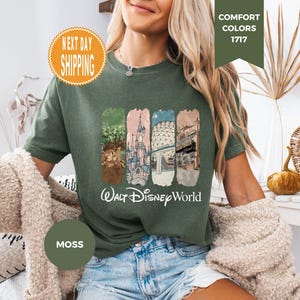 May include: Moss green t-shirt featuring four rectangular panels with Disney World imagery and the words "Walt Disney World" in white. The shirt has a crew neck and short sleeves. The shirt is a Comfort Colors 1717.