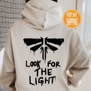TLOU Look For The Light Unisex Heavy Blend Hoodie, The Last Of Us Hoodie, Ellies Tattoo Hoodie, Tlou Fan Hoodie, Ellie and Joe Hoodie