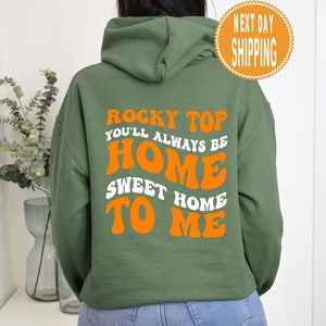May include: A green hooded sweatshirt with the text "Rocky Top You'll Always Be Home Sweet Home To Me" in orange letters.