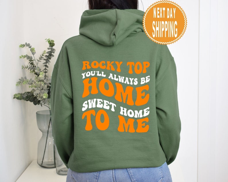 May include: A green hooded sweatshirt with the text "Rocky Top You'll Always Be Home Sweet Home To Me" in orange letters.