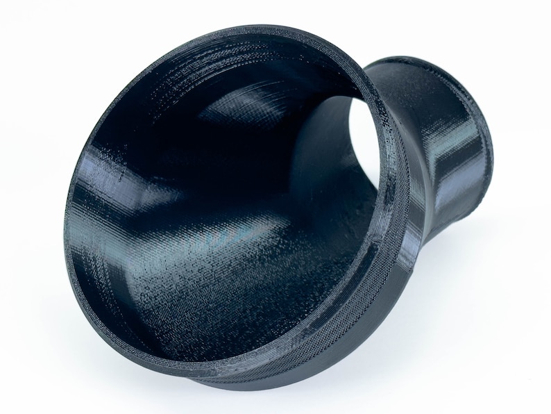 May include: A black 3D printed plastic funnel with a wide opening and a narrower outlet.