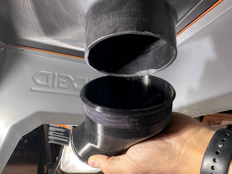 May include: Two black plastic dust collection adapters. The top adapter is a straight pipe, and the bottom adapter is a 90-degree elbow.