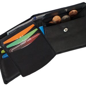 May include: A black leather wallet with multiple card slots and a coin pocket. The wallet is open and has several cards and coins inside.