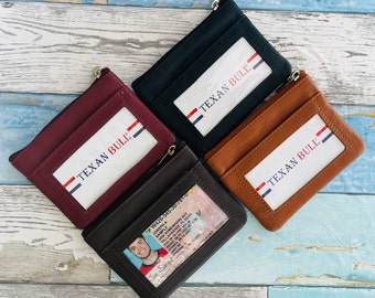 May include: Four leather zippered wallets with a clear window for identification. The wallets are in black, brown, burgundy, and dark brown. The wallets have the text "Texan Bull" printed on them.