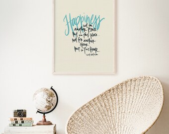 May include: A framed print with a white background and a blue and black quote that reads "Happiness is not in another place, but in this place... Not for another hour, but in this hour." - Walt Whitman