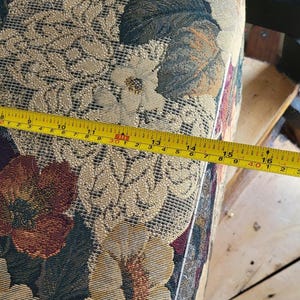 May include: Close-up of a floral patterned fabric with a yellow measuring tape along the edge. The tape reads 8, 9, 10, 11, 13, 14, 15, 16 inches.