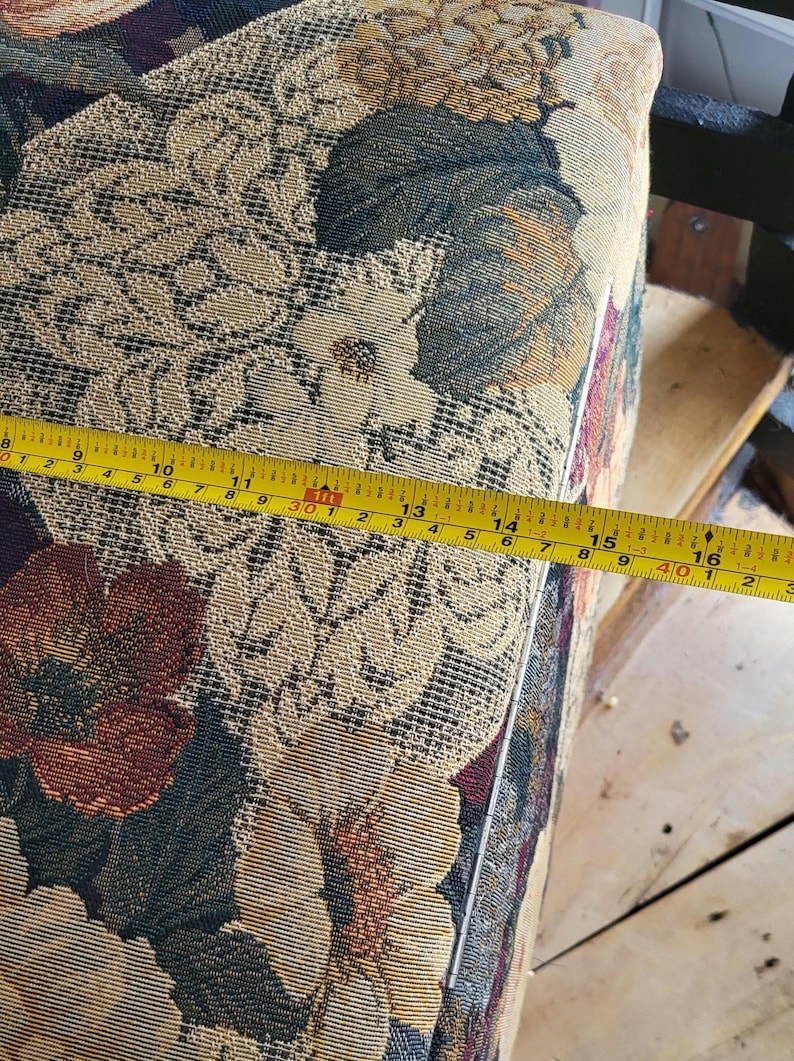 May include: Close-up of a floral patterned fabric with a yellow measuring tape along the edge. The tape reads 8, 9, 10, 11, 13, 14, 15, 16 inches.