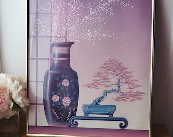 May include: Framed print depicting a dark blue vase with pink floral details and a bonsai tree in a blue pot. The background has a purple gradient and white dots. The frame is gold.