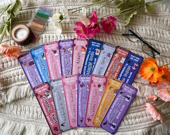 May include: A set of 16 colourful bookmarks featuring different book genres. Each bookmark is designed like a ticket with the words 'Lifetime Admission to' and the name of the genre. The genres include: 'Dark Romance', 'Psychological Thrilla', 'Cowboy Romance', 'Avenues to Lovers', 'Romance Lover', 'Cozy Sunshine', 'Fantasy Reader', 'Dark Mystery', 'Fairy Grey', 'Manight Matin', 'Spicy Reader', 'Anti Social', 'Fantasy Reader', 'Spooky Stories', 'Dark Romance', and 'Villain Lover'.
