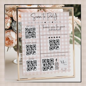 May include: A gold-framed sign with a pink and white gingham background. The sign reads "Scan to Pay" and includes QR codes for Venmo, Cash App, and Zelle. Text also says "Thank you for your purchase!" and "Follow us on Social media".