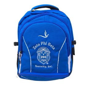 May include: Blue backpack with white embroidered text that reads "Zeta Phi Beta Sorority, Inc." and a crest with the letters "ZΦB" and the year "1920".