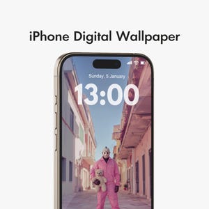 May include: An iPhone displaying a digital wallpaper featuring a person in a pink jumpsuit and hockey mask holding a teddy bear. The time is 13:00 on January 5th. The phone's screen is set against a backdrop of a street.