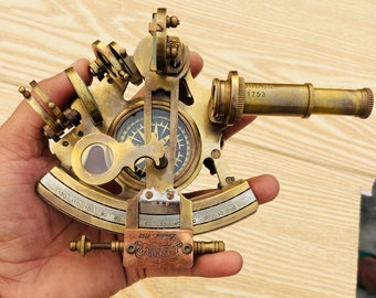 May include: A brass sextant with a compass and a telescope. The sextant has a scale marked in degrees and a vernier scale for precise measurements. The telescope is labeled "London 1753".