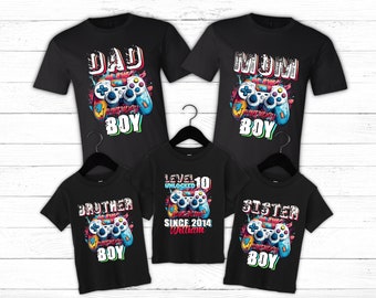 May include: A set of four black t-shirts with a video game controller graphic and text that says "Dad of the Birthday Boy", "Mom of the Birthday Boy", "Brother of the Birthday Boy", and "Level 10 Unlocked Since 2014 William Sister of the Birthday Boy".