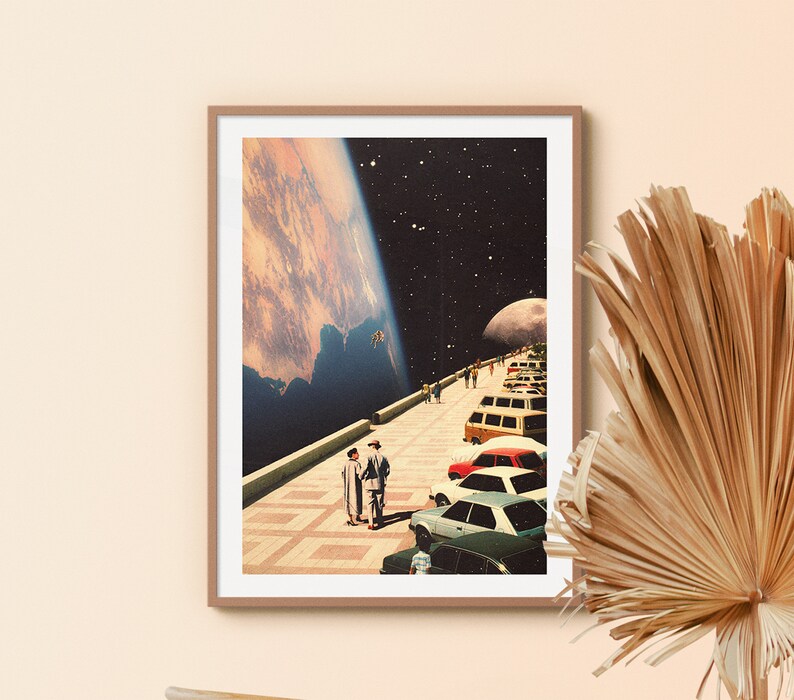 a picture hanging on a wall next to a plant