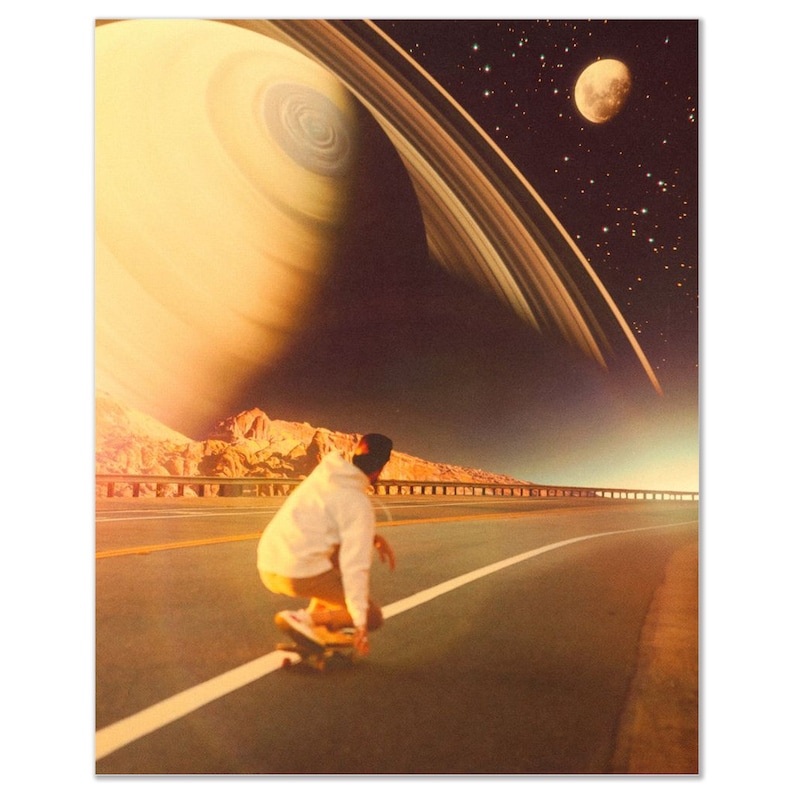 May include: A person in a white jacket and khaki pants rides a skateboard down a road. The road is surrounded by mountains and a large, bright planet with rings in the sky.
