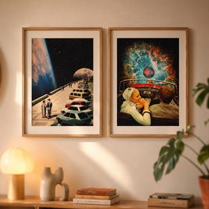 May include: Two framed art prints. One depicts a surreal scene of a road with cars leading to a planet and a couple. The other shows a couple in a convertible with a cosmic background. Both are in wooden frames.
