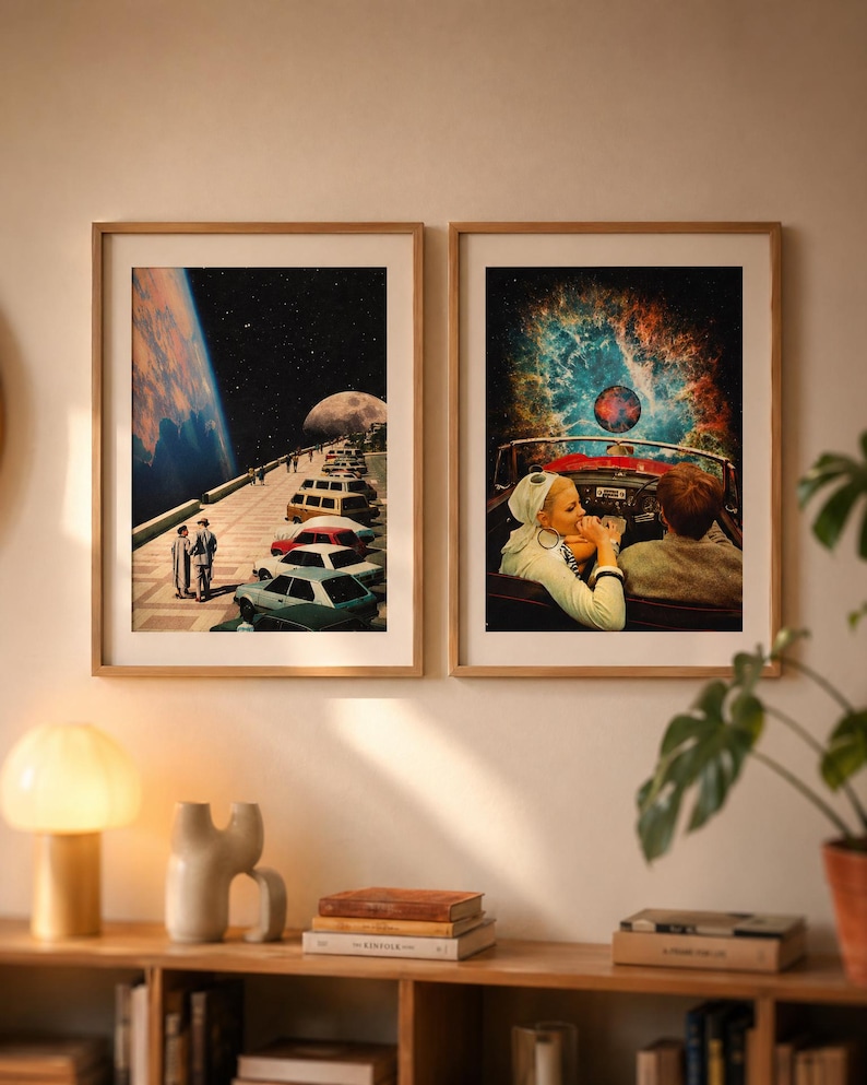 May include: Two framed art prints. One depicts a surreal scene of a road with cars leading to a planet and a couple. The other shows a couple in a convertible with a cosmic background. Both are in wooden frames.