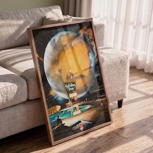 May include: A framed rectangular wall art print featuring a surreal illustration of a Holiday Inn sign and a swimming pool set against a large, glowing orange planet in a dark, starry space background with a striped umbrella and lounge chairs.
