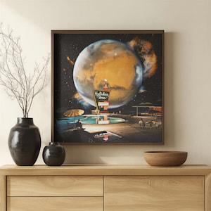 May include: A square framed wall art print depicting a surreal scene of a Holiday Inn sign and a swimming pool set against a large, glowing orange planet in deep space. The artwork features a dark night sky, a pool with umbrellas, and a planet.