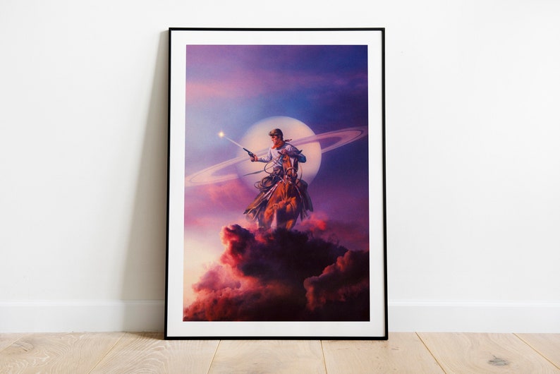 May include: A cowboy riding a horse in front of a large, bright moon with a ring around it. The cowboy is holding a gun and is looking to the left. The background is a purple and pink sky with clouds.