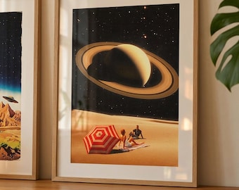 May include: Framed art print featuring a surreal scene with Saturn in a starry sky. A red and white striped umbrella shades two figures on a sandy beach. The artwork is in a light wood frame.
