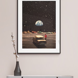 May include: A framed print of a surrealist collage depicting a car parked in a drive-in theater with the Earth visible in the night sky above.