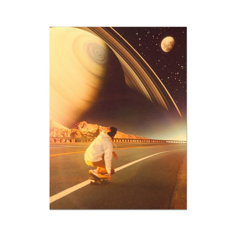 May include: A person in a white hoodie and khaki pants is skateboarding down a road. The road is lined with mountains and a large planet with rings is in the sky above.