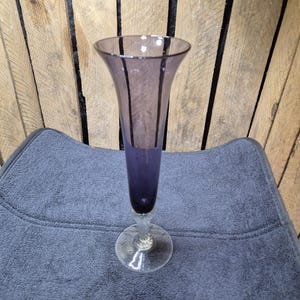 Stunning vintage tall purple glass vase with clear base and intricate design