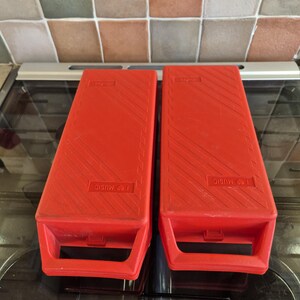 Two red cassette tape storage boxes