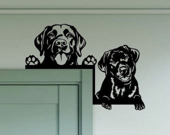 May include: Black and white silhouette of two Labrador Retrievers peeking over a door frame. The dogs are looking at the viewer with their tongues out. The image is a wall decal.