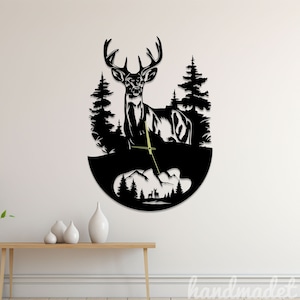 May include: Black silhouette wall clock featuring a deer standing in a forest setting. The clock hands are gold and the background is black.