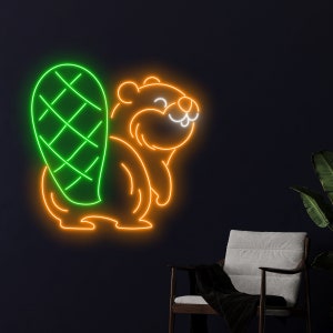 May include: A neon sign depicting a cartoon beaver. The beaver's body is outlined in orange, with a green tail. The sign is mounted on a dark blue wall. A chair and plant are visible in the background.