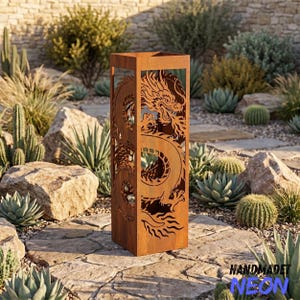 May include: A tall, rectangular, rust-colored metal fire pit column featuring a laser-cut design of a dragon on its side. The structure is open at the top and bottom, with intricate cutouts forming the dragon's body, scales, and claws.