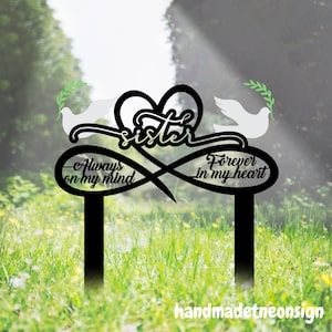 May include: Black metal garden stake with a white dove and the words "Sister", "Always on my mind", and "Forever in my heart".